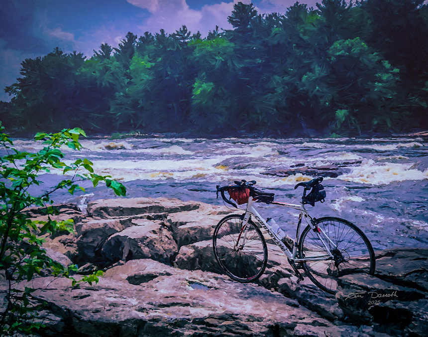 A Cannondale bicycle parked on a bedrock outcrop with foaming rapids of the Wisconsin River in the background.